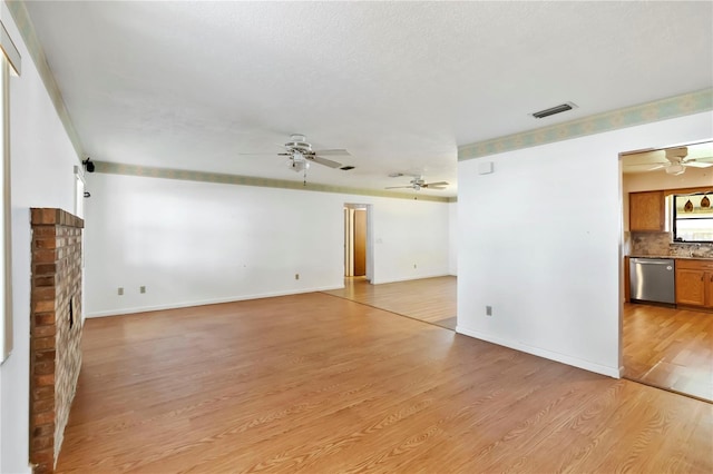2740 Barker Rd, Saint Cloud, FL 34771 - unfurnished living room featuring a ceiling fan and light wood-style floors