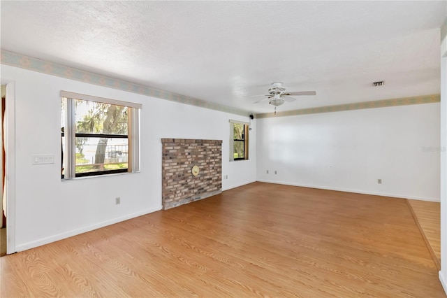 2740 Barker Rd, Saint Cloud, FL 34771 - unfurnished living room featuring plenty of natural light, a ceiling fan, and light wood-type flooring
