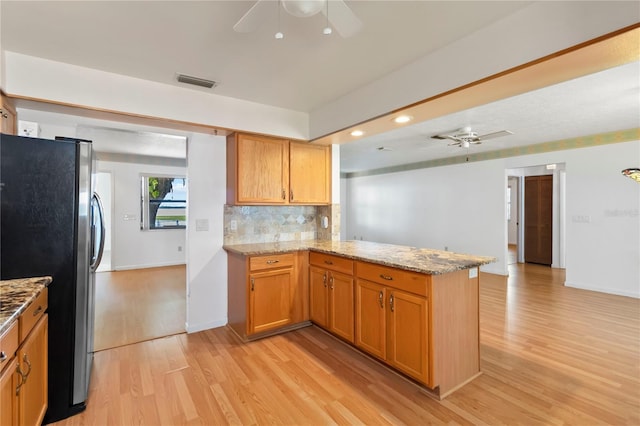 2740 Barker Rd, Saint Cloud, FL 34771 - kitchen featuring ceiling fan, freestanding refrigerator, light wood-style flooring, a peninsula, and recessed lighting