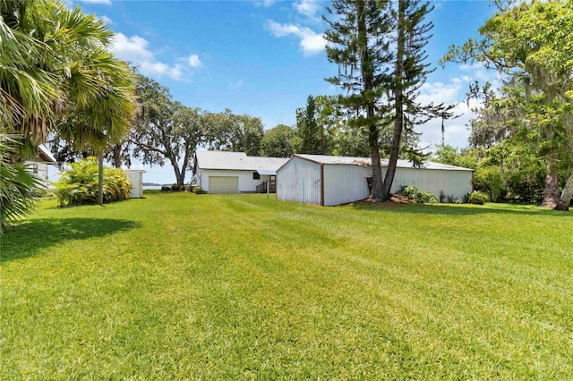 2740 Barker Rd, Saint Cloud, FL 34771 - view of grassy yard with a detached garage and an outdoor structure