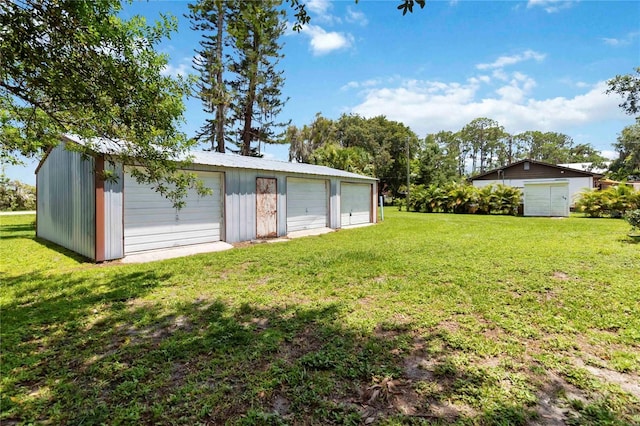 2740 Barker Rd, Saint Cloud, FL 34771 - view of green lawn with an outbuilding and a garage