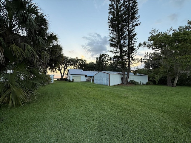 2740 Barker Rd, Saint Cloud, FL 34771 - yard at dusk with a yard and a detached garage