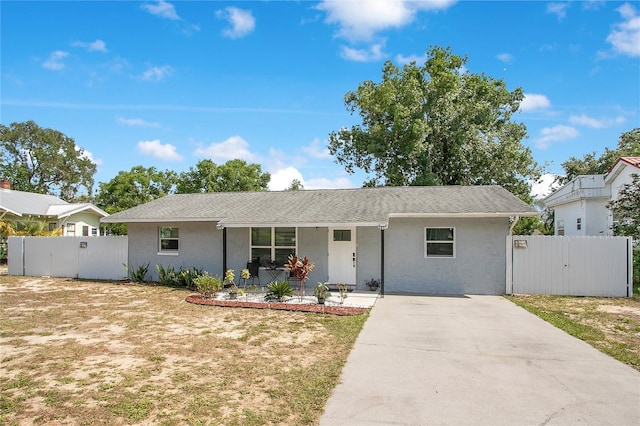 416 E Seminole Ave, Lake Wales, FL 33853 - ranch-style home with a gate, driveway, and stucco siding