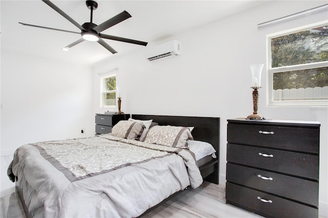 416 E Seminole Ave, Lake Wales, FL 33853 - bedroom with an AC wall unit, light wood finished floors, and a ceiling fan