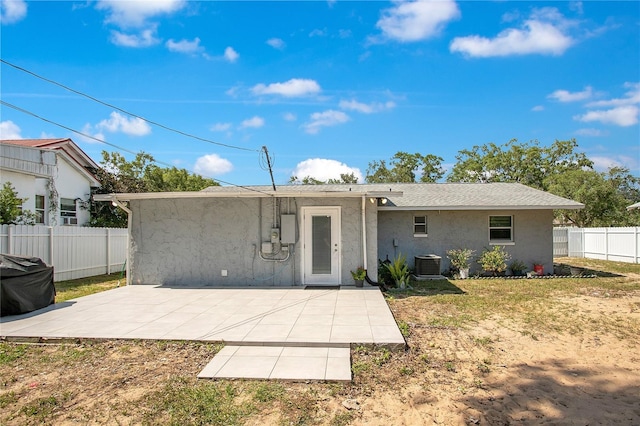 416 E Seminole Ave, Lake Wales, FL 33853 - rear view of property with central AC, stucco siding, and a patio area