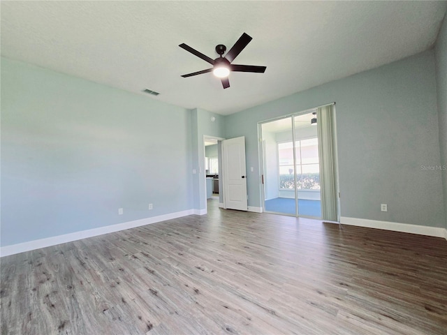 2312 Twickingham Ct, Clermont, FL 34711 - empty room featuring wood finished floors, a ceiling fan, and baseboards