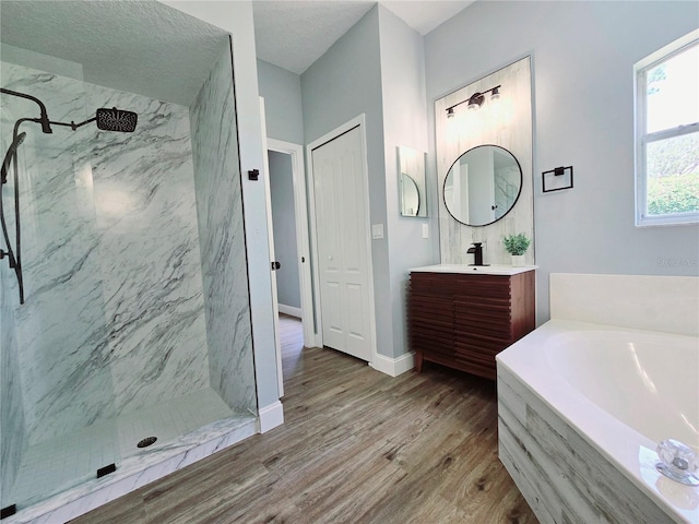 2312 Twickingham Ct, Clermont, FL 34711 - full bath featuring a garden tub, vanity, a marble finish shower, wood finished floors, and baseboards