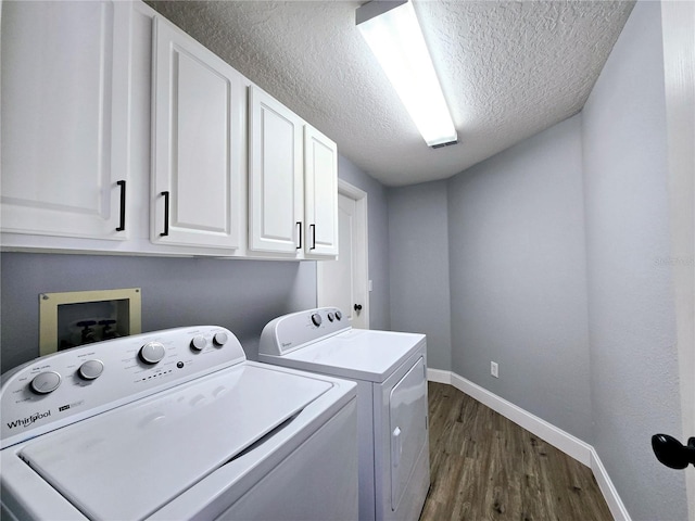 2312 Twickingham Ct, Clermont, FL 34711 - washroom featuring cabinet space, washer and dryer, dark wood-style flooring, baseboards, and a textured ceiling