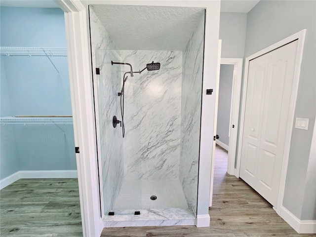 2312 Twickingham Ct, Clermont, FL 34711 - full bath with a marble finish shower, wood finished floors, and baseboards