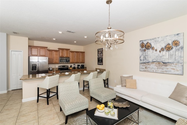 4875 Clock Tower Dr, Kissimmee, FL 34746 - living room with a chandelier, light tile patterned floors, baseboards, and recessed lighting