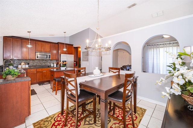 812 Adour Dr, Kissimmee, FL 34759 - dining space with lofted ceiling, light tile patterned floors, and a chandelier