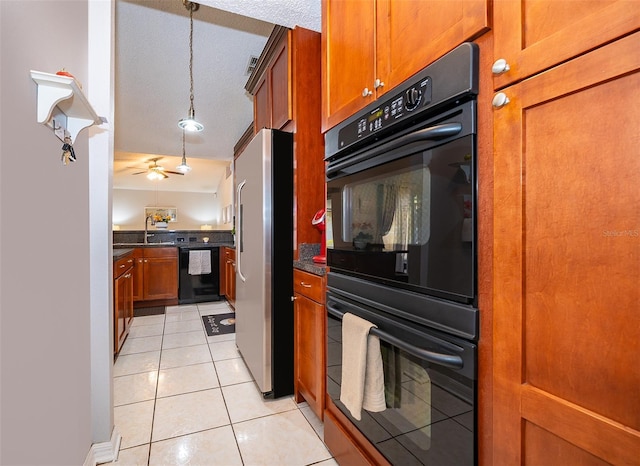 812 Adour Dr, Kissimmee, FL 34759 - kitchen with black appliances, brown cabinetry, dark countertops, and light tile patterned floors