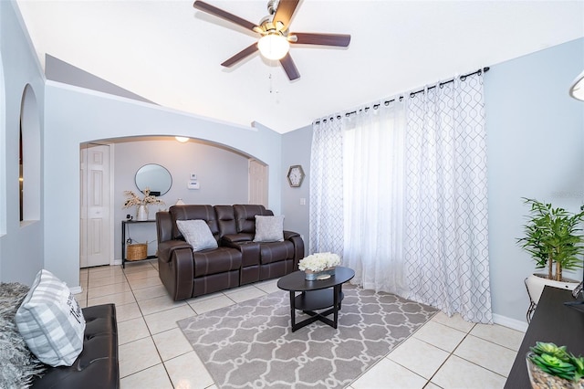 812 Adour Dr, Kissimmee, FL 34759 - living room featuring arched walkways, light tile patterned flooring, vaulted ceiling, and a ceiling fan