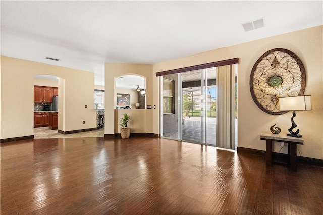 3759 Eagle Isle Cir, Kissimmee, FL 34746 - entrance foyer with arched walkways, light wood finished floors, and baseboards