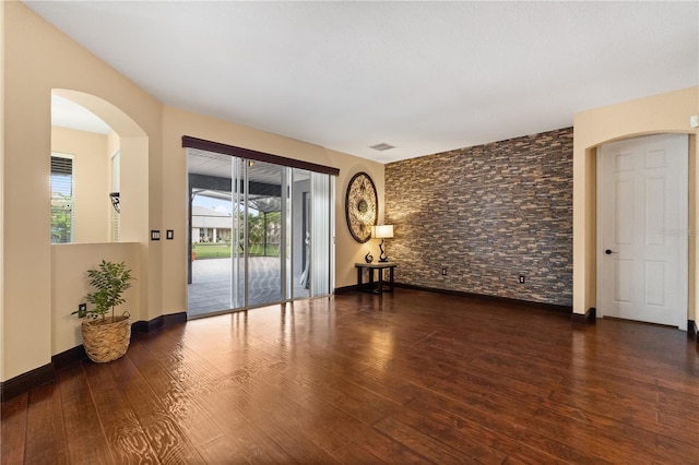 3759 Eagle Isle Cir, Kissimmee, FL 34746 - empty room featuring wood finished floors and arched walkways