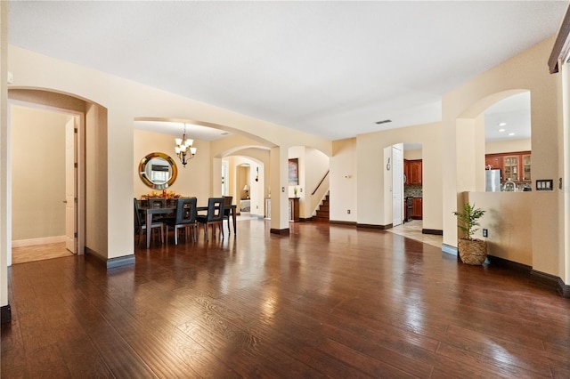 3759 Eagle Isle Cir, Kissimmee, FL 34746 - living room featuring stairway, hardwood / wood-style flooring, baseboards, and arched walkways
