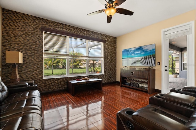 3759 Eagle Isle Cir, Kissimmee, FL 34746 - tiled living room featuring ceiling fan, baseboards, and an accent wall