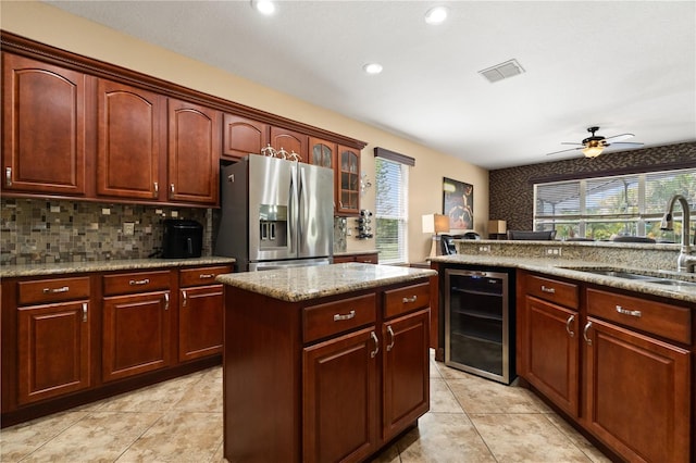 3759 Eagle Isle Cir, Kissimmee, FL 34746 - kitchen with stainless steel fridge, wine cooler, a sink, tasteful backsplash, and light tile patterned floors