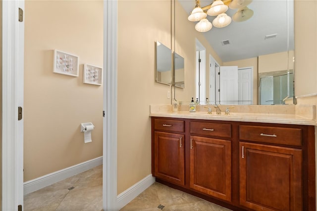 3759 Eagle Isle Cir, Kissimmee, FL 34746 - bathroom with vanity, a chandelier, baseboards, and tile patterned floors