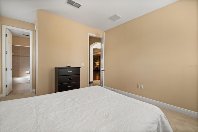 3759 Eagle Isle Cir, Kissimmee, FL 34746 - carpeted bedroom with arched walkways, baseboards, and ensuite bath
