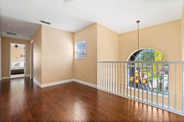 3759 Eagle Isle Cir, Kissimmee, FL 34746 - empty room with a chandelier, hardwood / wood-style floors, and baseboards