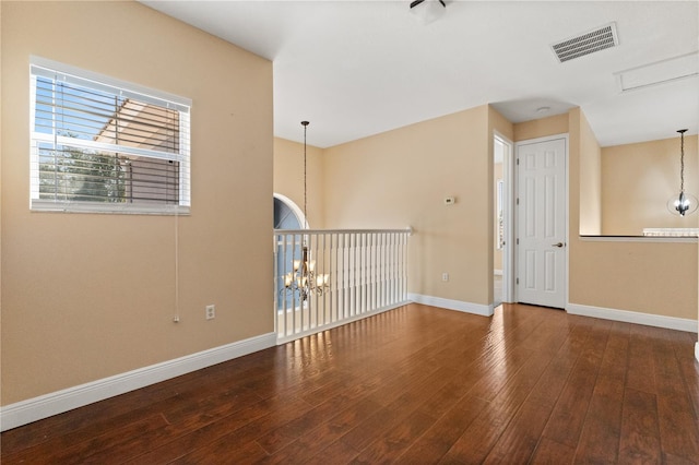 3759 Eagle Isle Cir, Kissimmee, FL 34746 - unfurnished room featuring wood-type flooring, a chandelier, and baseboards