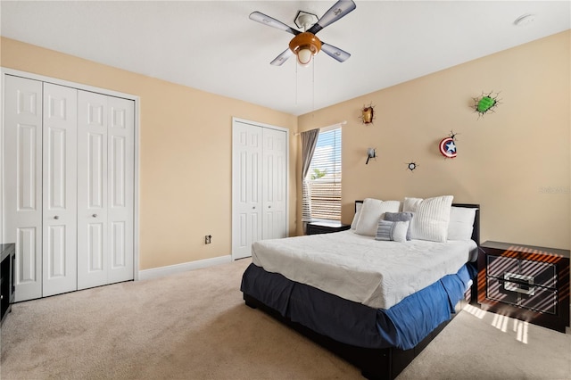 3759 Eagle Isle Cir, Kissimmee, FL 34746 - bedroom with multiple closets, carpet flooring, baseboards, and a ceiling fan