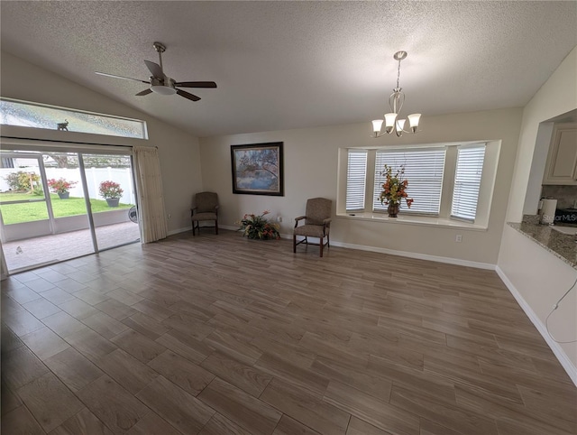 5921 Lake Champlain Dr, Orlando, FL 32829 - unfurnished room with a textured ceiling, lofted ceiling, a chandelier, healthy amount of natural light, and wood finished floors