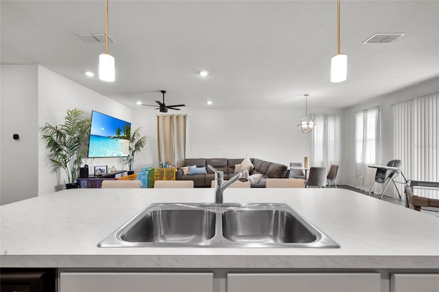 685 Overpool Ave, Davenport, FL 33896 - kitchen featuring open floor plan, light countertops, an island with sink, and recessed lighting