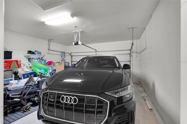 685 Overpool Ave, Davenport, FL 33896 - garage featuring a garage door opener and concrete block wall
