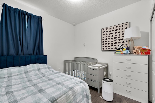 685 Overpool Ave, Davenport, FL 33896 - bedroom with wood finished floors and a textured ceiling