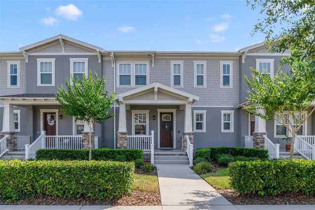 2224 Celebration Blvd, Celebration, FL 34747 - townhome / multi-family property featuring a porch and stucco siding