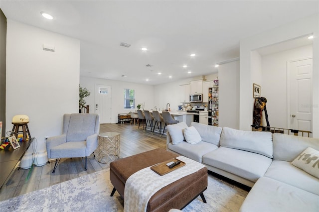 2224 Celebration Blvd, Celebration, FL 34747 - living area with light wood-style flooring and recessed lighting