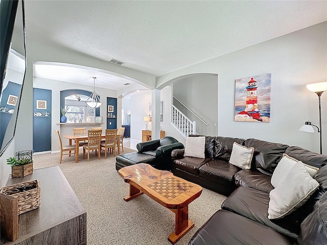 1426 Park Park, Haines City, FL 33844 - living area featuring arched walkways, carpet, stairs, and a textured ceiling