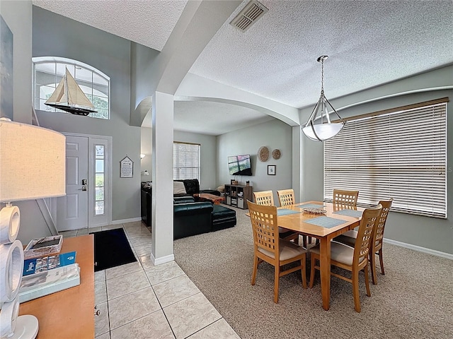 1426 Park Park, Haines City, FL 33844 - dining space featuring arched walkways, light carpet, a textured ceiling, and light tile patterned floors