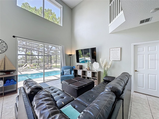 1426 Park Park, Haines City, FL 33844 - living area featuring a towering ceiling, light tile patterned flooring, and healthy amount of natural light