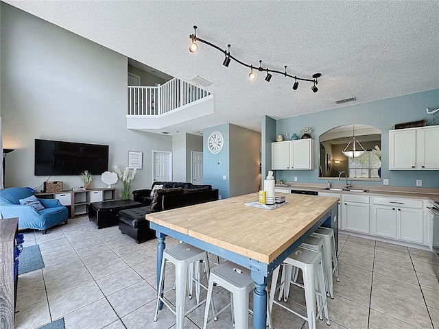 1426 Park Park, Haines City, FL 33844 - kitchen with open floor plan, white cabinetry, light tile patterned floors, and a textured ceiling