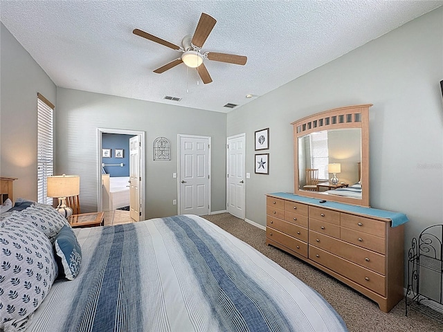 1426 Park Park, Haines City, FL 33844 - carpeted bedroom with a textured ceiling, ceiling fan, and ensuite bath