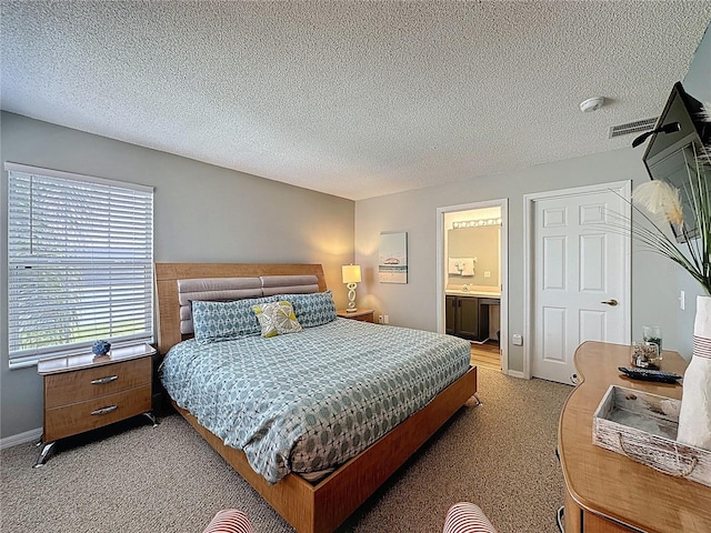 1426 Park Park, Haines City, FL 33844 - bedroom with light colored carpet, a textured ceiling, and ensuite bathroom