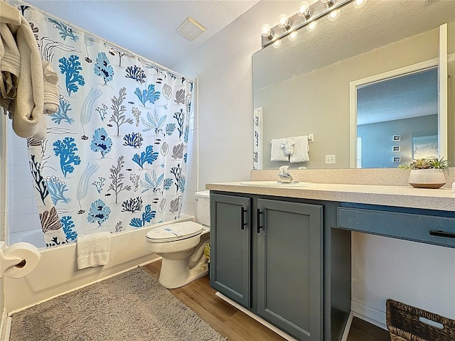 1426 Park Park, Haines City, FL 33844 - full bath featuring wood finished floors, vanity, shower / bathtub combination with curtain, and a textured ceiling