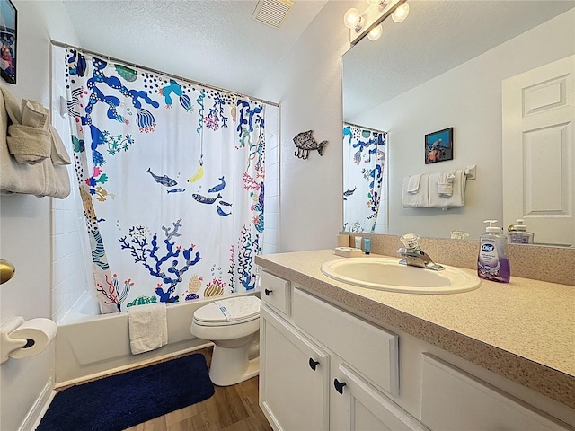1426 Park Park, Haines City, FL 33844 - bathroom featuring vanity, wood finished floors, shower / tub combo with curtain, and a textured ceiling