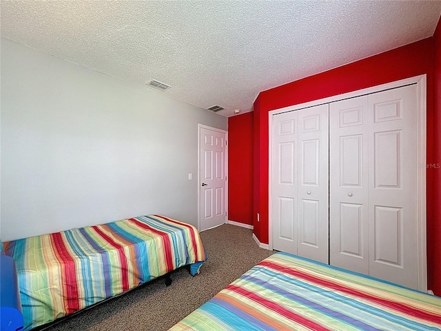 1426 Park Park, Haines City, FL 33844 - bedroom with carpet floors, a textured ceiling, and a closet