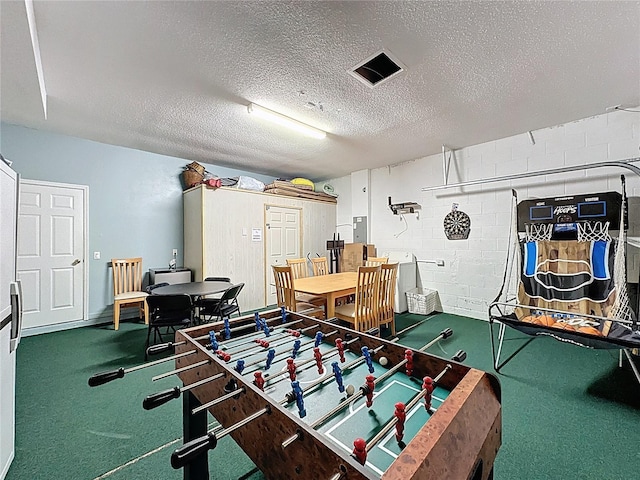 1426 Park Park, Haines City, FL 33844 - game room featuring concrete block wall, a textured ceiling, electric panel, and carpet flooring