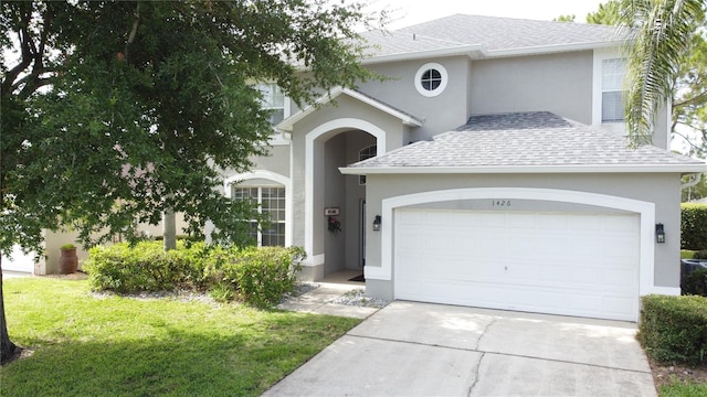 1426 Park Park, Haines City, FL 33844 - traditional-style house featuring a garage, stucco siding, driveway, and roof with shingles