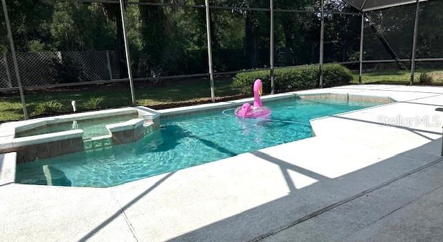 401 Chinahill Ct, Apopka, FL 32712 - view of pool featuring a lanai, a patio area, and a pool with connected hot tub