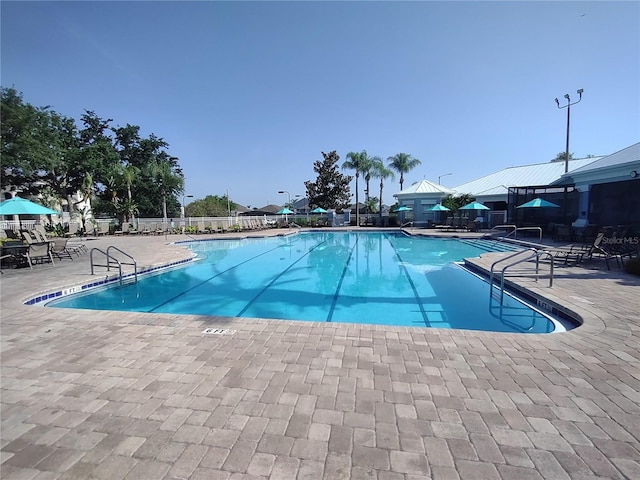 8101 Coconut Palm Way Unit 303, Kissimmee, FL 34747 - community pool featuring a patio area