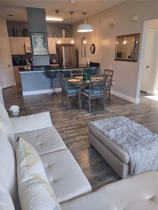 8101 Coconut Palm Way Unit 303, Kissimmee, FL 34747 - living room with dark wood-style floors and baseboards