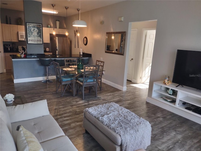 8101 Coconut Palm Way Unit 303, Kissimmee, FL 34747 - living room featuring dark wood-type flooring and baseboards