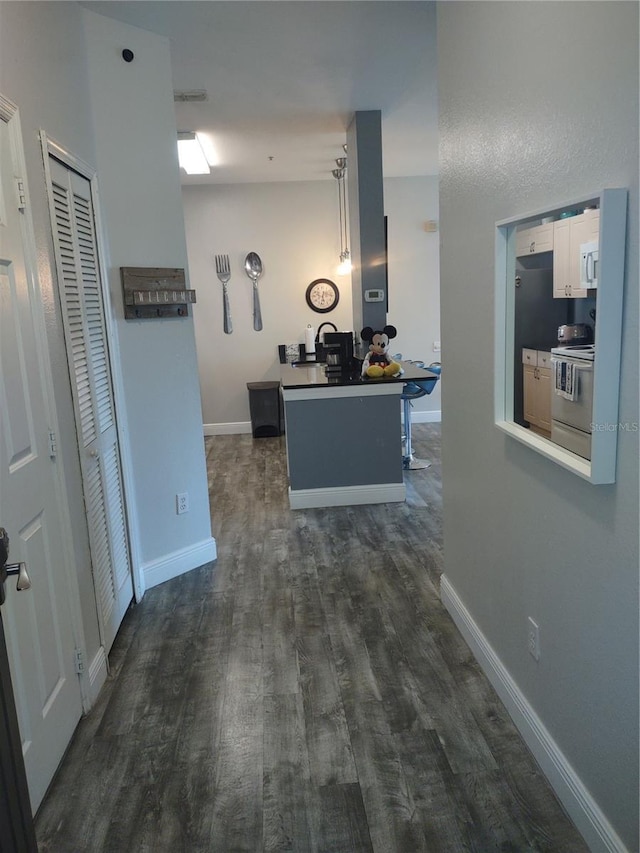 8101 Coconut Palm Way Unit 303, Kissimmee, FL 34747 - hallway with dark wood-style flooring and baseboards