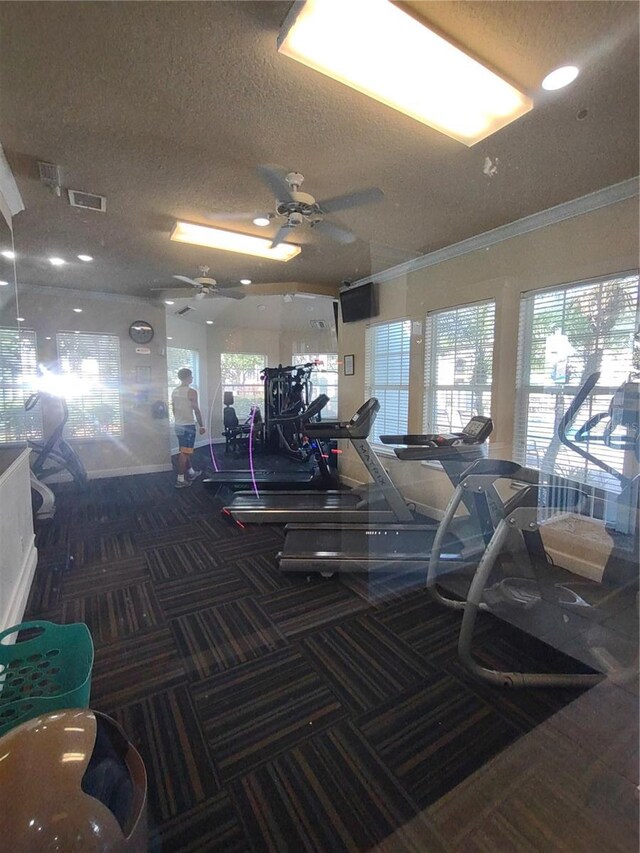 8101 Coconut Palm Way Unit 303, Kissimmee, FL 34747 - exercise room featuring carpet, ornamental molding, a textured ceiling, ceiling fan, and baseboards